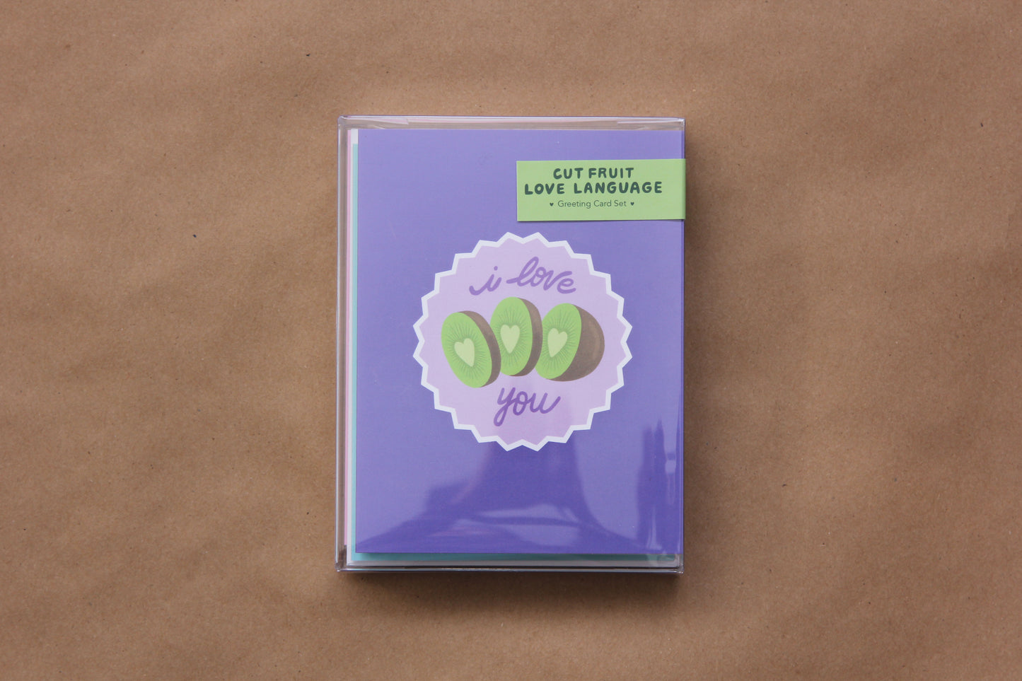 A photo of a clear box of the Cut Fruit Love Language Greeting Card Set.