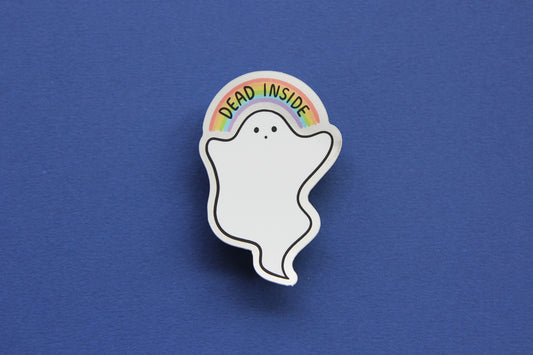 A JaneLi.Co sticker that shows a little white ghost holding up a rainbow that says "Dead Inside" over a navy blue background. The sticker has a metallic silver border.